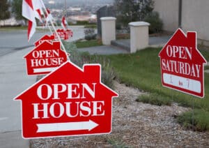 Red and white open house signs promoting a real estate open house
