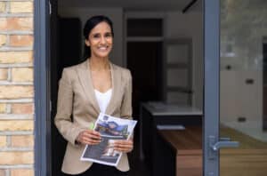 real estate agent holding marketing materials for a home for sale