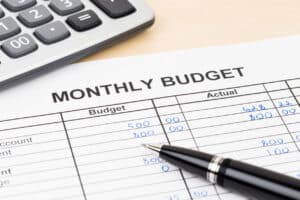 Home budget planning sheet with pen and calculator
