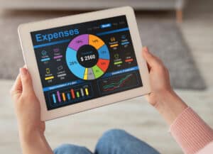 real estate agent with digital tablet, calculating her monthly spendings